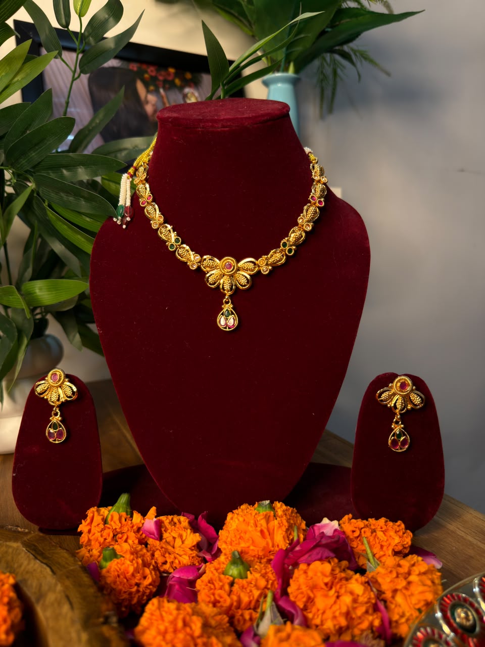 Antique gold necklace and earrings set with ruby red and green accents