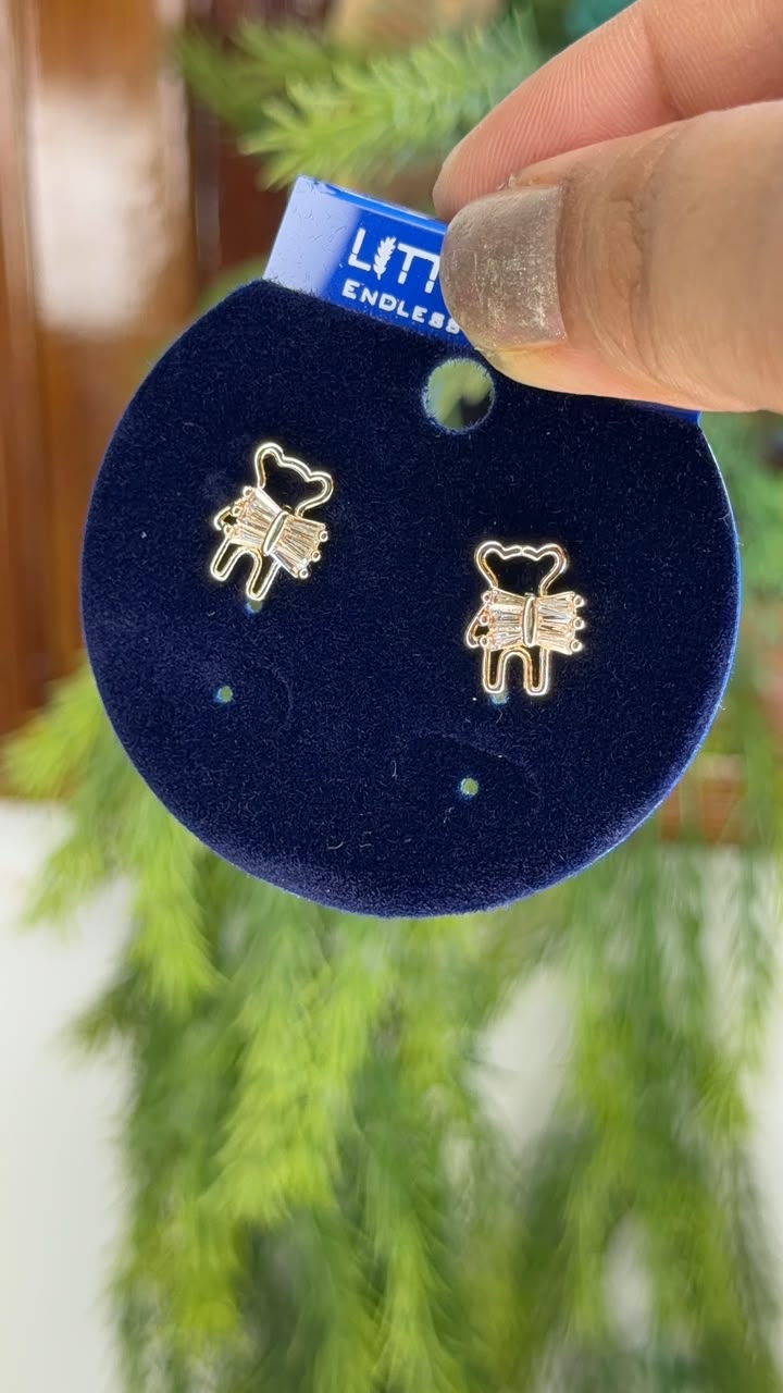 Gold tone teddy bear stud earrings with crystal bow detail