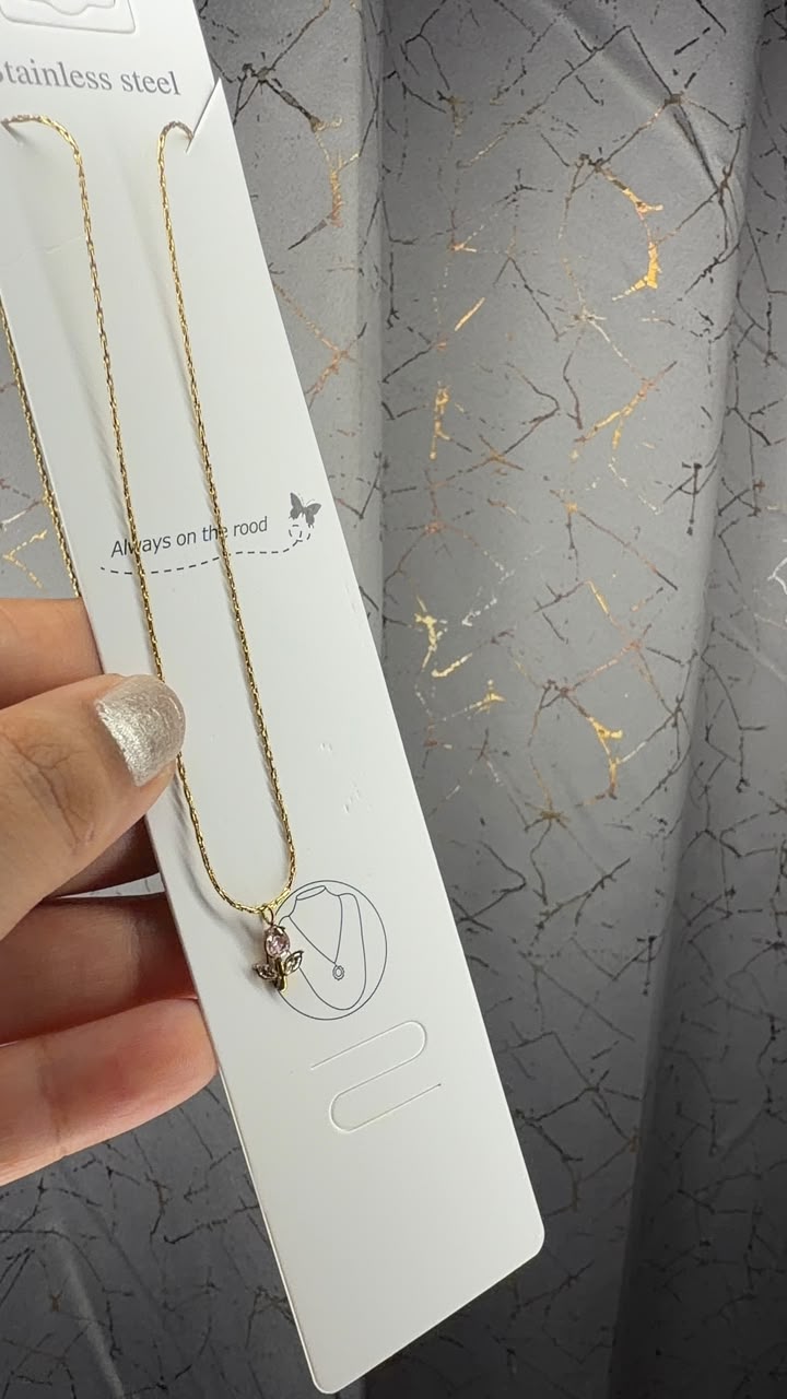 Delicate gold tone chain necklace with tiny butterfly pendant