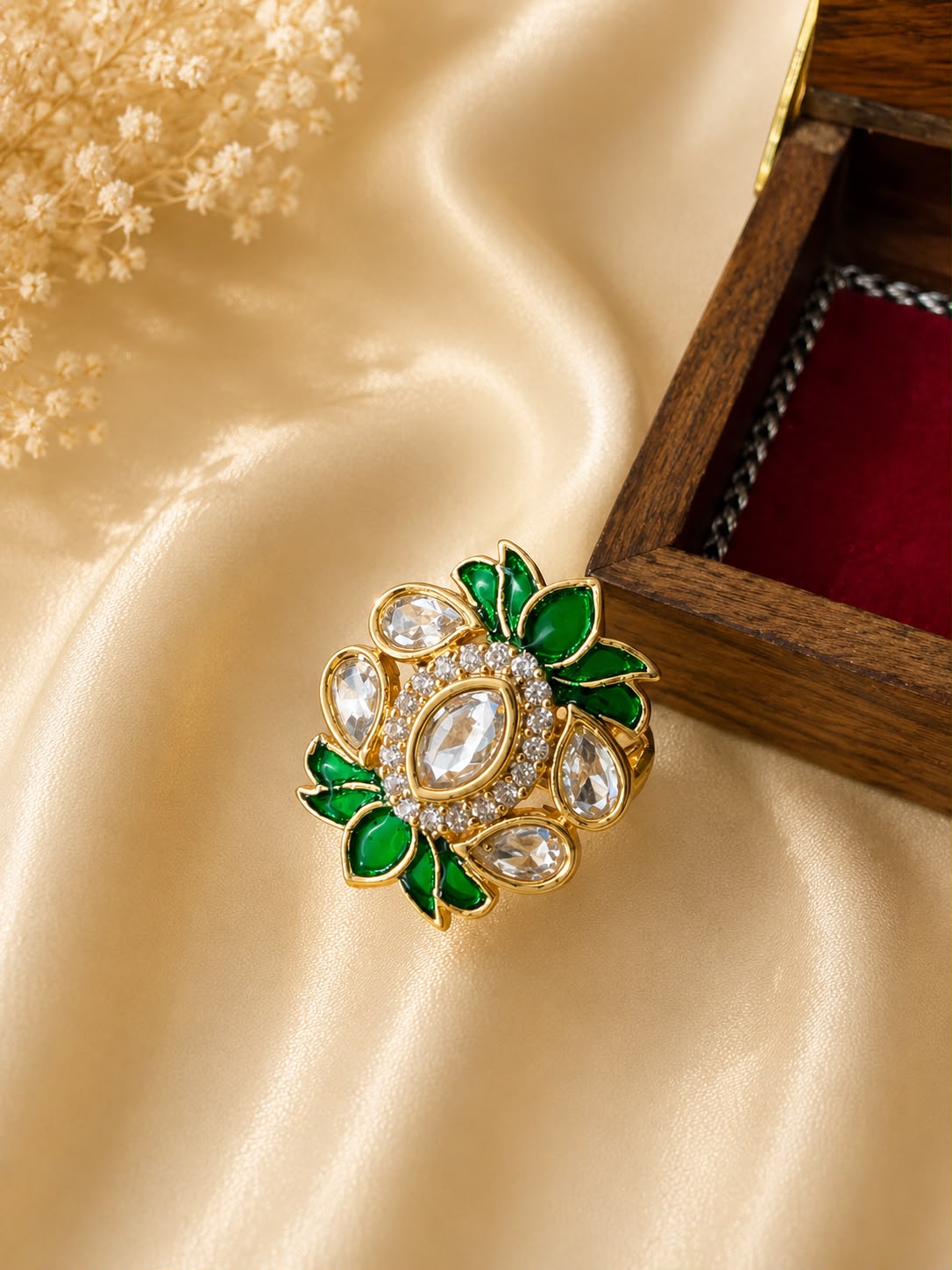 Gold tone kundan statement ring with emerald green floral enamel accents