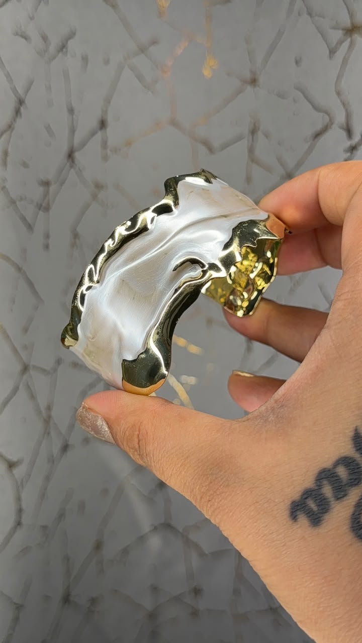 Wide ivory and gold tone sculpted statement cuff bracelet