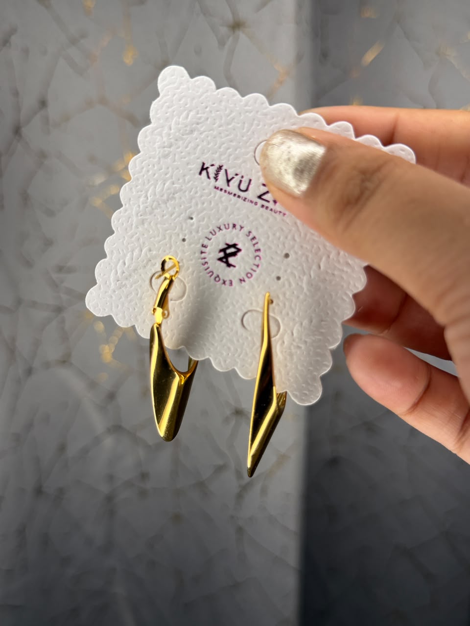 Sleek sculptural gold tone twist drop earrings